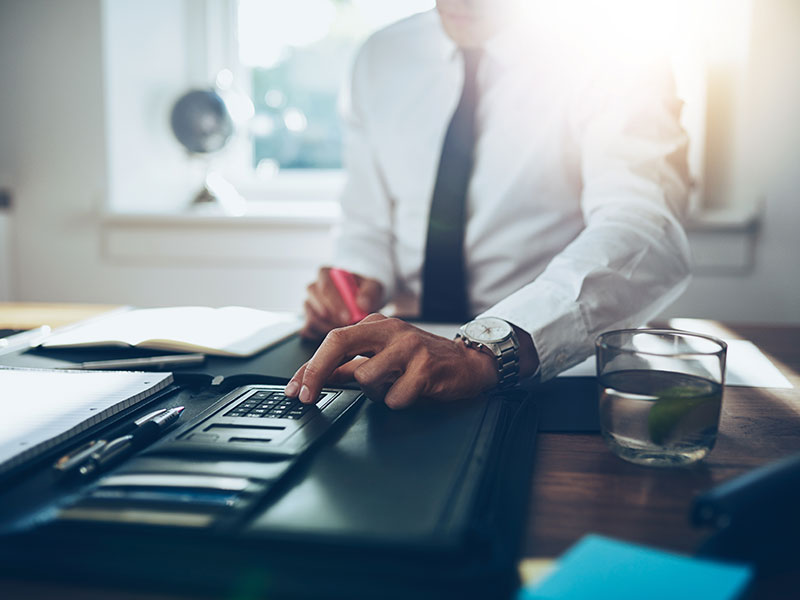 Business Man Using Calculator